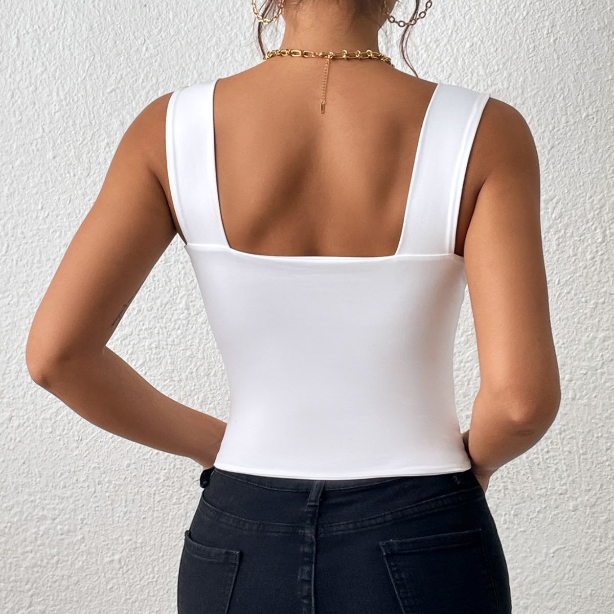 Sleeveless vest with wide shoulders and straps