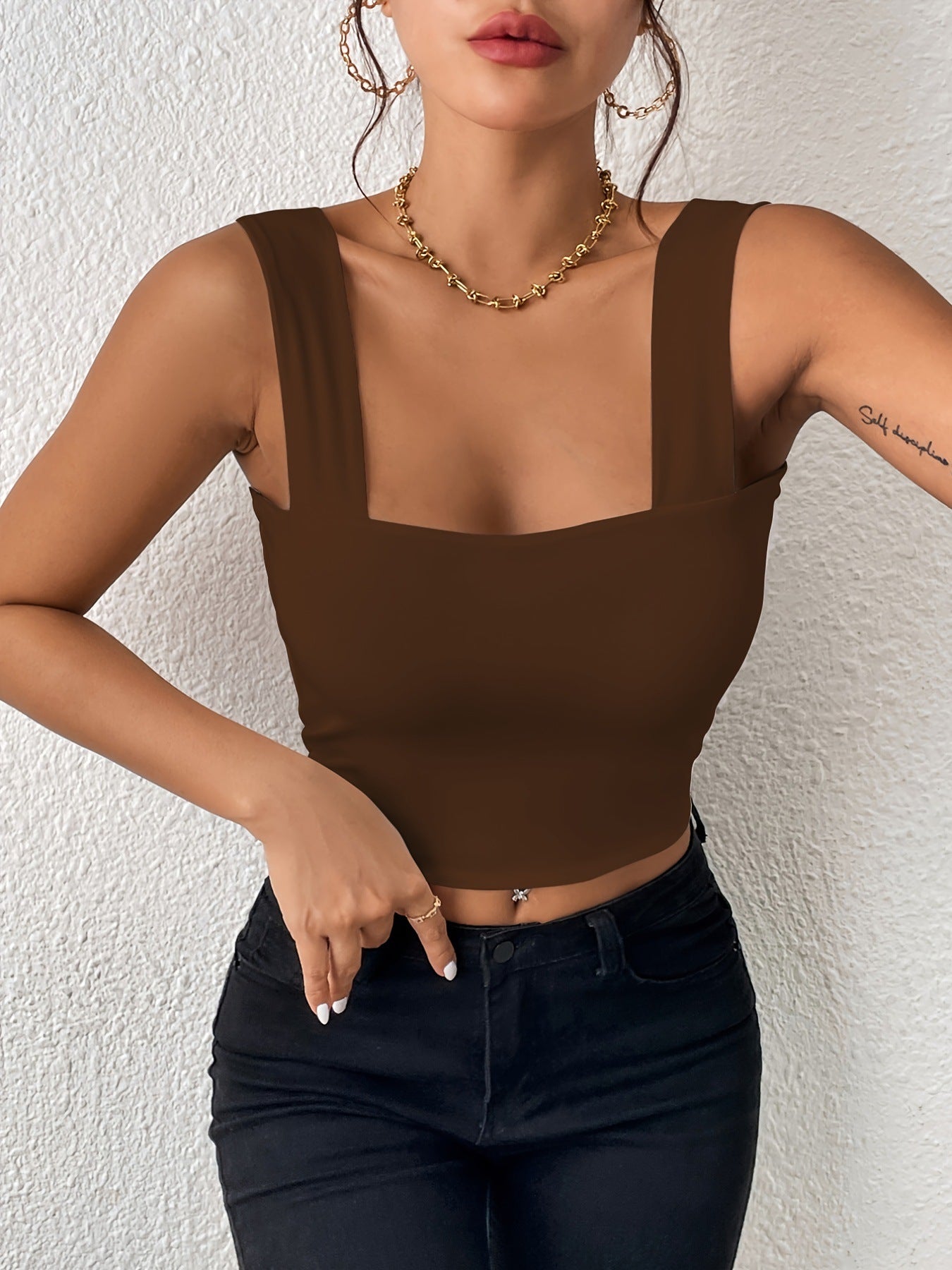 Sleeveless vest with wide shoulders and straps